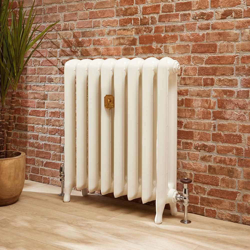 Traditional cast iron radiator against a brick wall