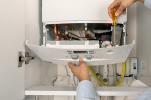 Technician repairing combi gas boiler